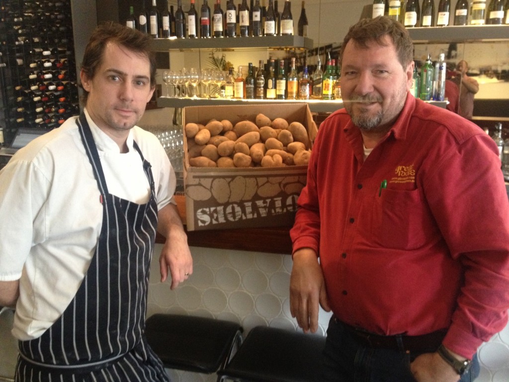 Chef Paul Cooper takes delivery of a box of Andean Sunrise potatoes from Keith Platt 